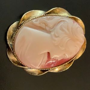 This classic cameo brooch will add a touch of elegance to any look.